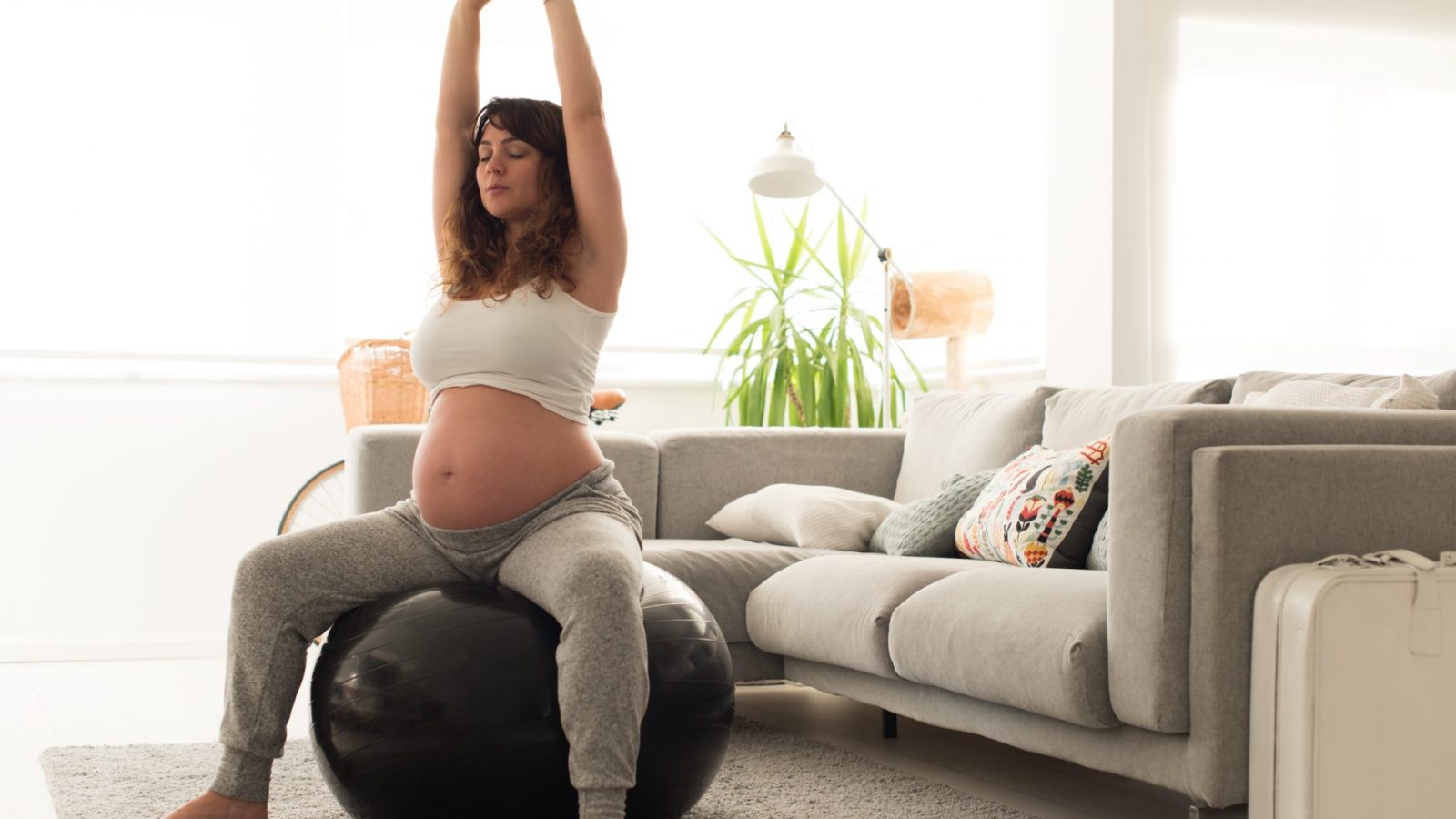 Exercise in pregnancy woman doing exercises with a fitness ball