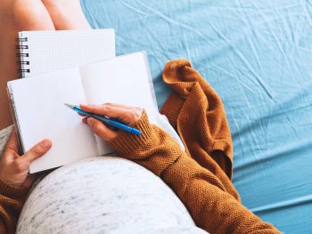 Pregnant woman writing her birth plan