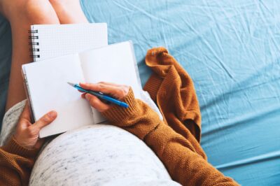 Pregnant woman writing her birth plan