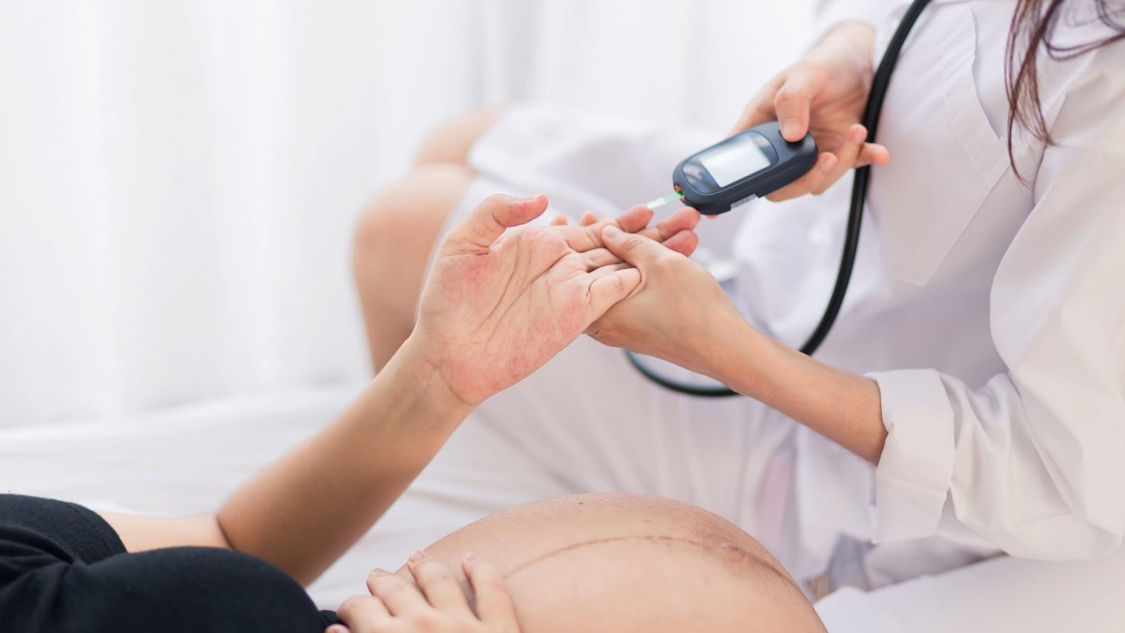 Female Obstetrician doctor checking for Gestational diabetes during pregnancy
