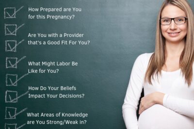 Pregnant-woman-standing-in-front-of-black-board