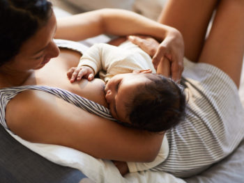 Beautiful black mom breastfeeding her newborn