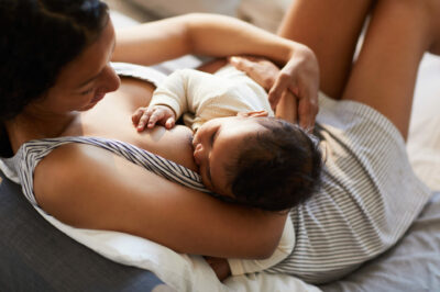 Beautiful black mom breastfeeding her newborn