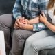 couple-holding-hands-at-first-prenatal-appointment