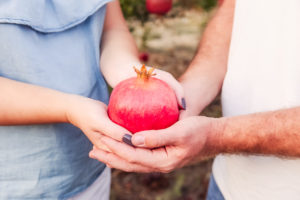 couple-holding-pomegranate