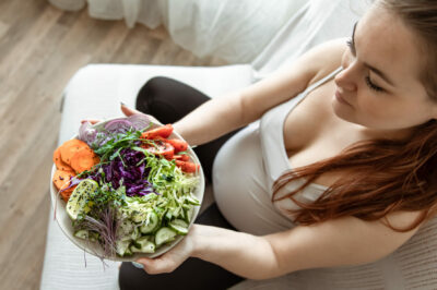 pregnant-woman-eating-plate-of-vegetables-for-a-healthy-microbiome