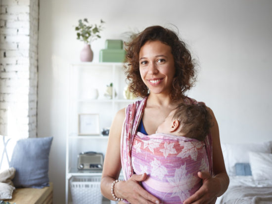 mom-with-child-sleeping-in-baby-sling