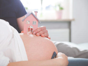Pregnant-belly-with-small-wooden-house