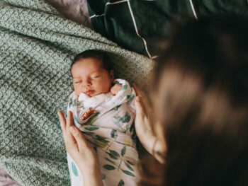 newborn-baby-swaddled-with-mom